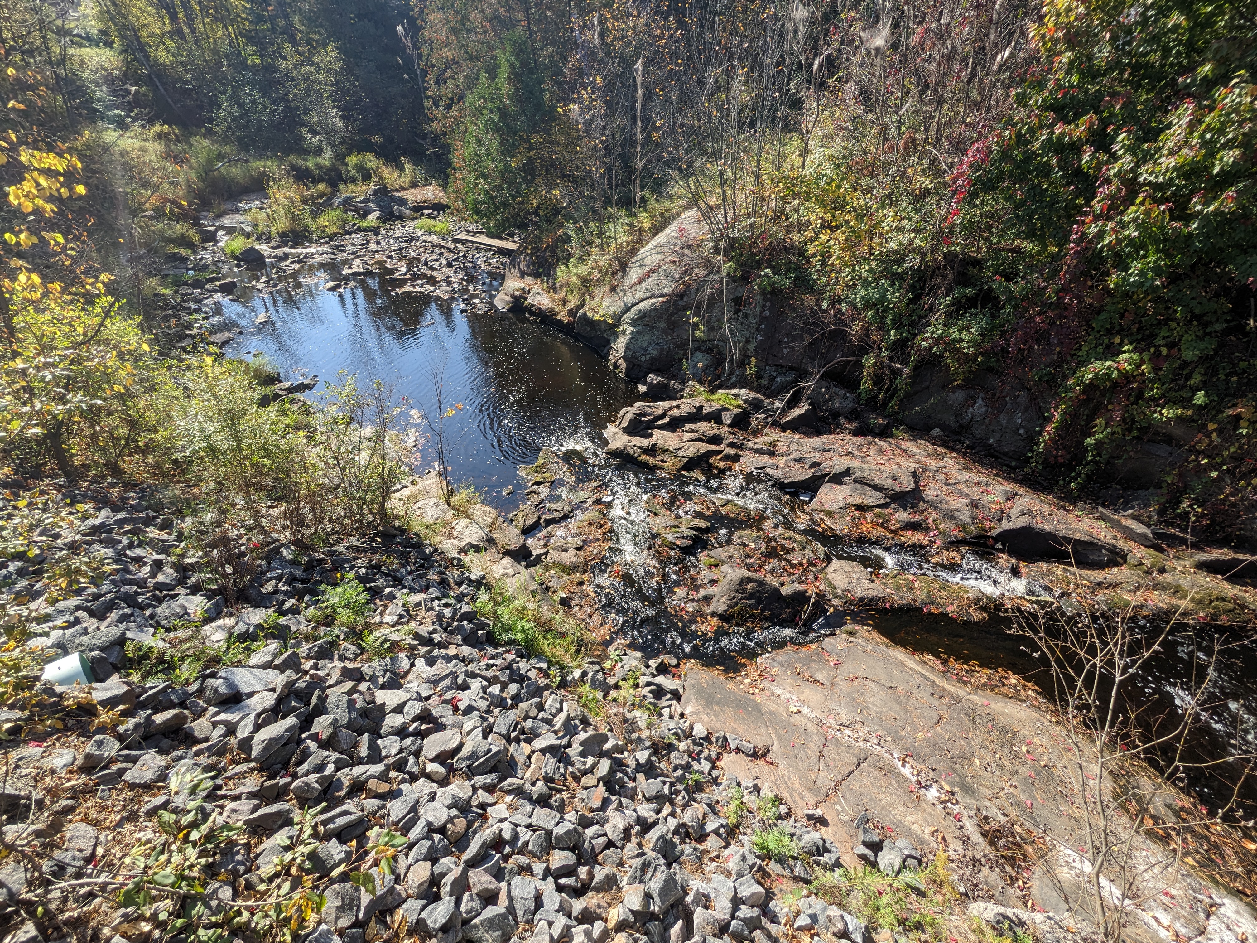 river flowing next to rocks